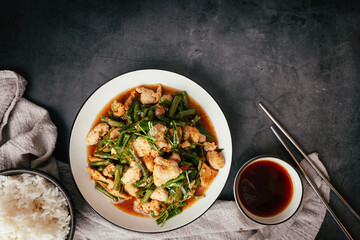 Top view,  Stir-fried pork and red hot curry paste with or long bean and Ingredients are oyster sauce, fish sauce, sugar, kaffir lime leaves in the dish Eat with cooked rice. Thai food