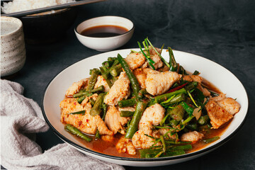 Close up Tasty Stir-fried pork and red hot curry paste with or long bean and Ingredients are oyster sauce, fish sauce, sugar, kaffir lime leaves in the dish Eat with cooked rice. Thai food