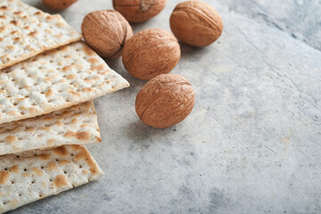 Passover celebration concept. Matzah, red kosher and walnut. Traditional ritual Jewish bread...