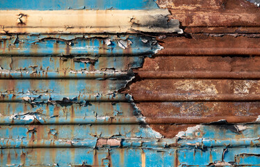 pattern rusty metal surface with remnants of blue and yellow paint paint