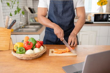 Man preparing food in kitchen at home.