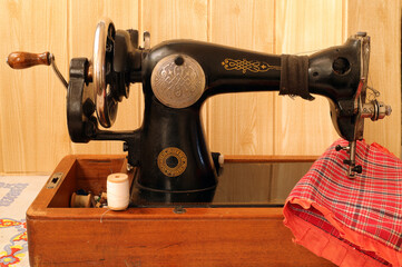 vintage hand-operated sewing machine and sewing supplies