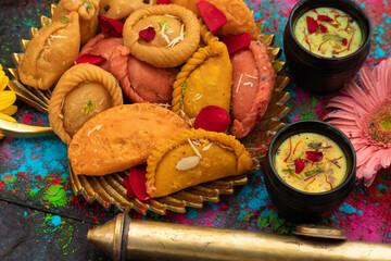 Indian Festival Of Colors Holi Is Celebrated With Colorful Gulal Abeer, Kesar Pista Badam Thandai, Gujiya, Mawa Potli Gujia, Chandrakala, Mithai, Water Gun, Dry Fruits, Bhang, Laung Latta, Samosa