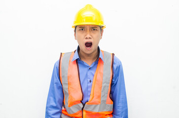 stressed over work concept illustrated by asian male construction worker in blue shirt, orange vest and yellow safety helmet with furious, mad, sad, angry expression. overworked concept
