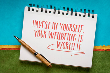 Invest in yourself, your wellbeing is worth it. Inspirational writing in a notebook, self care concept.