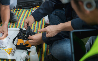 Engineer is inspecting connecting fiber optic and optical distribution frame with splicing machine.