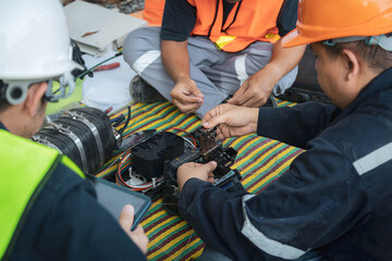 Engineer is inspecting connecting fiber optic and optical distribution frame with splicing machine.