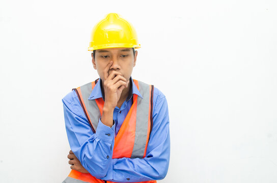 thoughtful asian male construction worker in pensive mood doing thinking and wondering gesture.