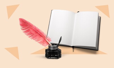 Retro pen feather and book on pastel background