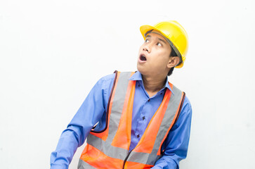 overjoyed asian male construction worker opening mouth shocked and surprised. construction worker with wow expression.