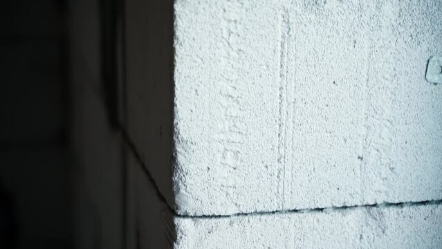 Aerated concrete brick wall close-up. Window opening in the gas block wall, smooth camera movement