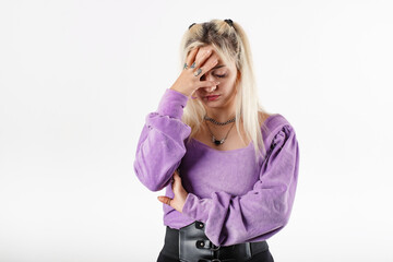 Blonde woman wearing blouse standing isolated over white background feeling bad sick covering forehead with hand. Touching forehead having headache migraine or depression, upset frustrated troubled.