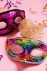 Festive face mask for carnival or masquerade celebration on colored background