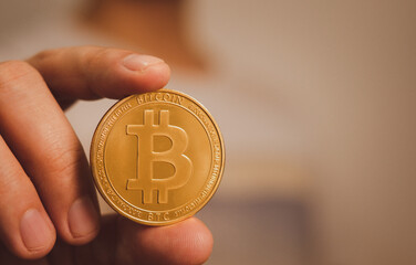 bitcoin holding by hand of young teenager represent of future economy and cryptocurrency business in the future