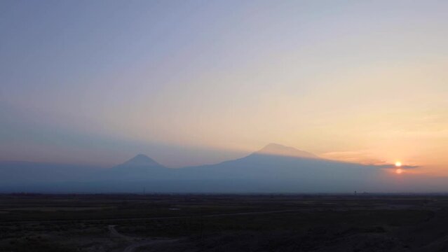 Time lapse of sunset and mount Ararat on a winter day. Clouds drop beautiful shadows when sunlight passes through them.