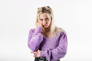 Young blonde woman isolated over white background very bored and waits with head resting on the...