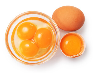 Brown chicken egg and egg yolks in glass bowl on white background. Clipping path.