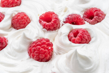 Fresh raspberries in the yoghurt or cream. Top view.