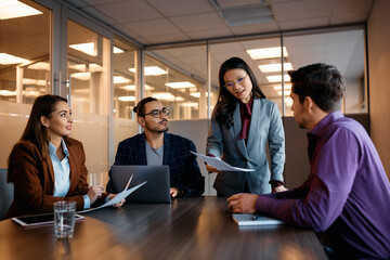 Multiracial group of business people having meeting in office.