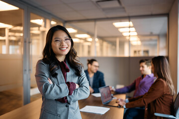 Confident female business leader during meeting in office looking at camera.