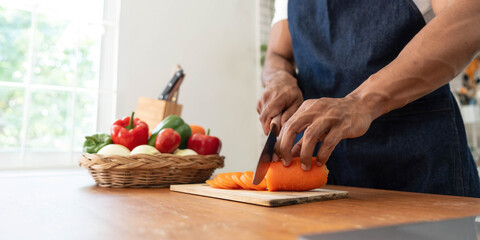Closeup portrait of asian man making salad at home. cooking food and Lifestyle moment