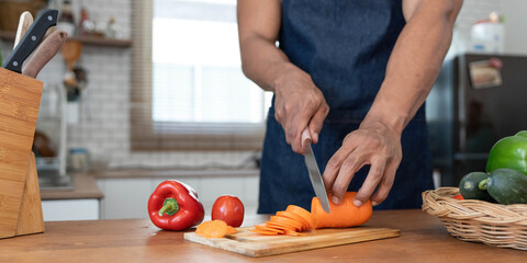 Closeup portrait of asian man making salad at home. cooking food and Lifestyle moment