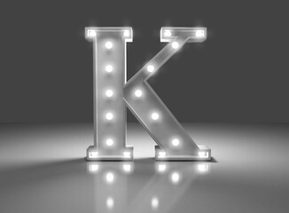 Letra luminosa k en fondo gris 