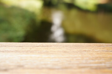 Empty wood table top and blur glass window wall building banner mock up abstract background - can...