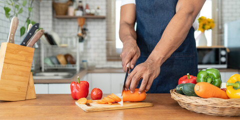 Closeup portrait of asian man making salad at home. cooking food and Lifestyle moment