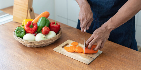 Closeup portrait of asian man making salad at home. cooking food and Lifestyle moment
