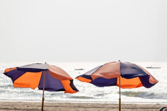 Colorful umbrellas of a beach shack with a view of the sea at the beach in Calangute in Goa.
