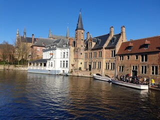 Classic panoramic view of the historic city center of Bruges (Brugge), West Flanders province, Belgium. Cityscape of Bruges with canal. Brugge streets and historic centre of medieval historic city.