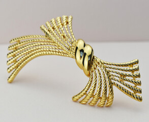 Old vintage brooch on beige background, accent retro jewelry for women
