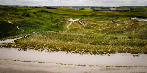Picturesque sand hills of Ireland, top view. Sand dunes covered with vegetation. Irish landscape.