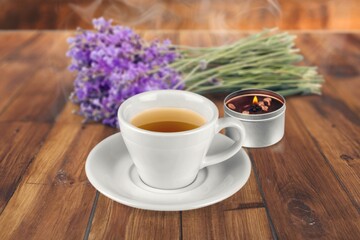 A cup of tasty fresh tea and burning aroma candles