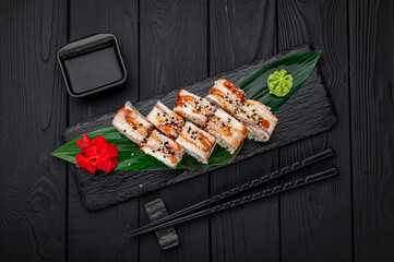 Sushi rolls japanese food on a dark background. Roll with eel