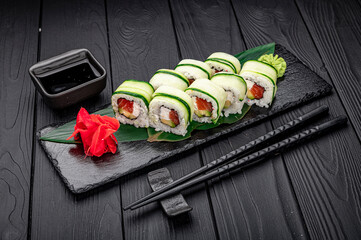 Sushi roll with salmon and cream cheese wrapped in cucumber