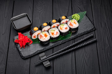 Sushi rolls with salmon, crab, shrimps and spicy sauce
