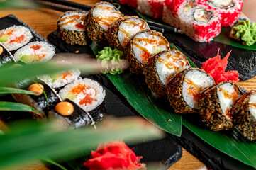 Big set of Asian food. Sushi and rolls on a dark background.