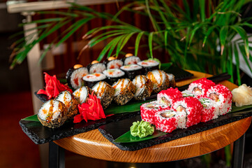 Big set of Asian food. Sushi and rolls on a dark background.