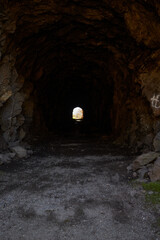 dark tunnel with bright, light and dark ending