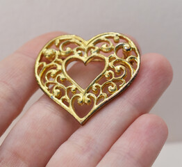 Vintage brooch on a woman's hand, old retro jewelry