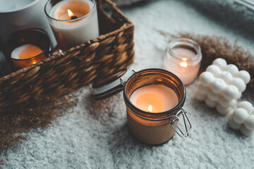 Fototapeta na wymiar Burning candle in cozy home interior
