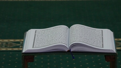 Quran - the holy islamic book on the lauh in the mosque. baca quran. ayo mengaji. close up Quran