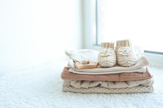 Stack of stylish baby items on white background