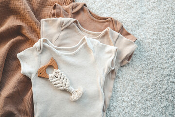 Set of stylish cute baby bodysuits and a handmade toy