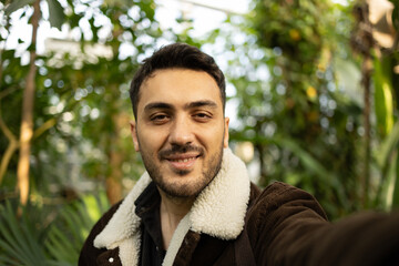 Young tourist man taking selfie in forest.