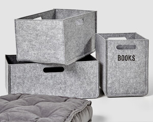 Gray felt baskets for storing books and velour seat cushion