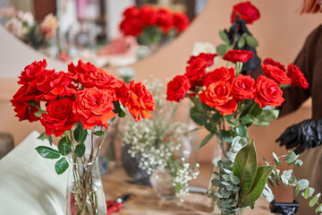 Obraz na płótnie Canvas Red rose. Florist prepares flowers. Fresh delivery in flower shop. European floral shop. Delivery fresh cut flower.