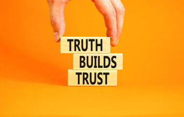 Truth builds trust symbol. Concept words Truth builds trust on wooden blocks on a beautiful orange...